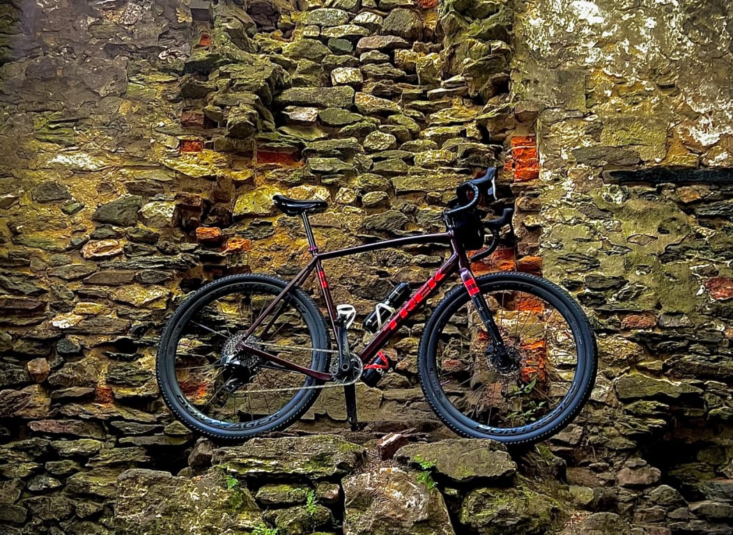 Road bike with Bontrager tires leaning on an old brick and stone wall
